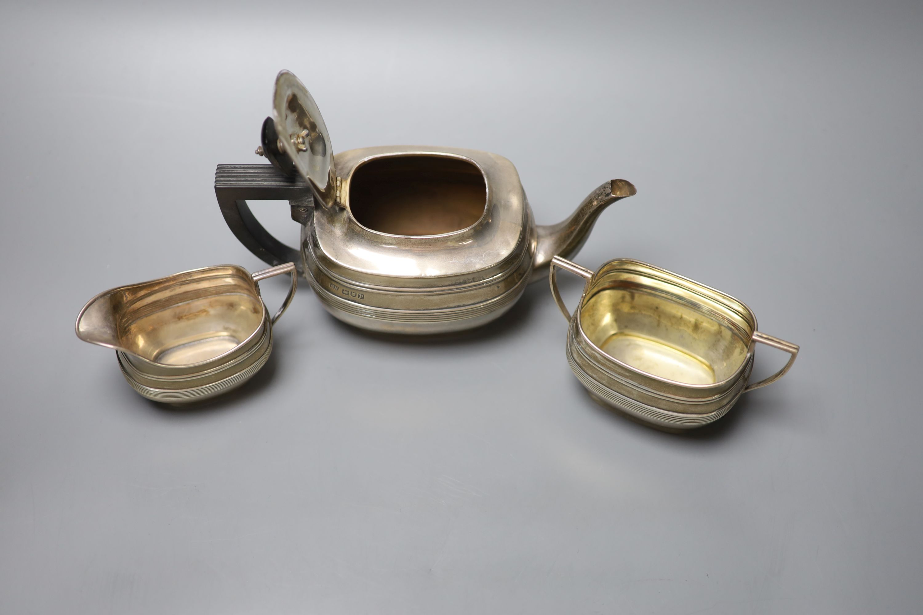 A George V reeded silver oval three piece tea set, George Howson, London, 1910, gross 16oz.